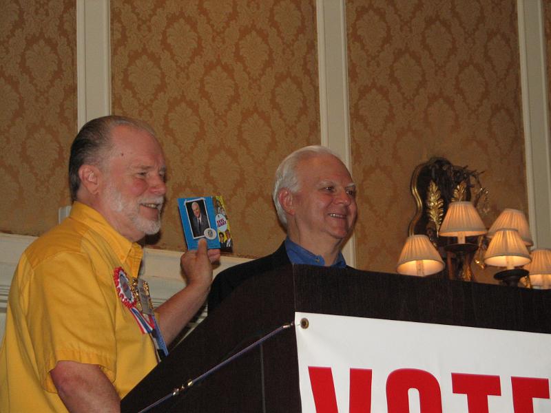 IMG_3636.JPG - At the Kiwanis International Convention it begins with the district caucus on Thursday morning.  Campaign chair PG John Tyner and candidate Jerry Peuler give instructions to the CDK delegates on how and where to campaign, and discuss the terrific campaign literature created by Jen Dugent.